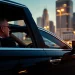 Experience Chauffeur Hire with a professional chauffeur in a luxurious sedan against a city skyline.