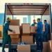 Efficient Toronto movers loading furniture into a truck amidst the city's skyline.