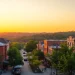 View of Clarksburg's vibrant downtown during sunset with historic buildings and parks.